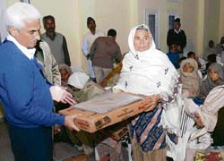 Deputy Commissioner B.S. Malik honours a war widow on the occasion of Vijay Diwas in Karnal on Sunday.