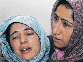An injured woman with a relative in a hospital on Sunday. She was injured on Saturday after the police fired on protesters demanding a degree college in Magam, 30 km from Srinagar.