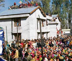BJP supporters perched atop the roof of the community health centre during a rally addressed by L.K. Advani at Fatehpur in Jwali on Monday.