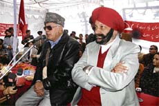 Former chief minister and National Conference patron Dr Farooq Abdullah addressing party workers in Jammu on Monday. Harbans Singh, a former minister and senior vice-president of the party, is sitting on Farooq's left.