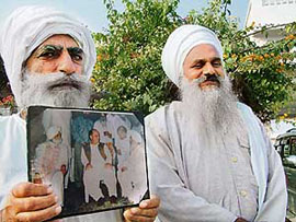 Bhai Gurmohinder Singh (born as a Muslim) holds his picture with Nawaz Sharif, former Prime Minister of Pakistan. Sitting by his side is Baba Sewa Singh, chief of the Kar Sewa Samprada, Khadoor Sahib.