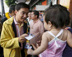 Thai Democrat party leader Abhisit Vejjajiva (left) meets supporters during an election campaign in Bangkok on Tuesday.