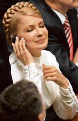 Ukraines new Prime Minister Yulia Tymoshenko smiles as she speaks on the phone after voting in Parliament in Kiev on Tuesday.