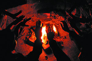 People try to warm up with firewood in the Capital on Wednesday.