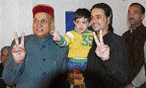 BJP chief ministerial candidate P.K. Dhumal, his son and grandson flash the victory sign after Dhumal cast his vote at Sameerpur on Wednesday.