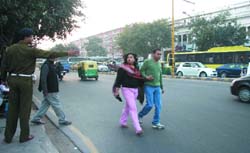 A policeman tries to stop pedestrians who are not using the zebra crossing in the Capital on Thursday.
