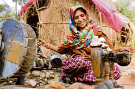 A nomad woman spinning wool on a traditional charkha on the outskirts of Jammu. The demand for woollen clothes has increased in Jammu following the cold wave in the North. 
