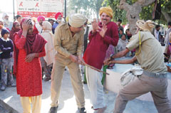 Artistes of the Narinder Kala Manch, Faridkot, enacting a nukkad play, Injj Ni Vasde Vehre at the civil hospital in Bathinda on Saturday.