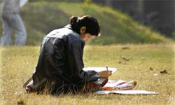 Taking advantage of a bright sunny day, a girl studies on the Jammu University campus on Saturday. 