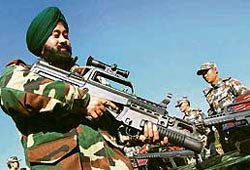 An Indian Army officer tries his hands at a weapon used by Chinese army during the Sino-Indian joint military excercise, Hand in Hand, at Kunming Military Academy on Saturday.
