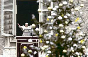 Pope Benedict XVI waves as he leads the Angelus prayer from the window of his private apartments at Saint Peters Square in the Vatican on Sunday.