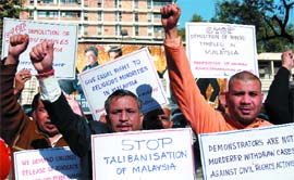 Activists of the Federation of Human Rights Organisations of India protest against the alleged discrimination against people of the Indian origin in Malaysia, near the Malaysian embassy, in the Capital, on Monday.