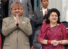 Nepals King Gyanendra and Queen Komal watch a chariot procession carrying Kumari, a prepubescent girl revered by many in Nepal as a living goddess, during the Indra Jatra Festival in Kathmandu.