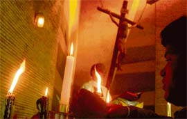 MERRY XMAS: A devotee lights a candle before Jesus at the Sector 19 church in Chandigarh on Tuesday
