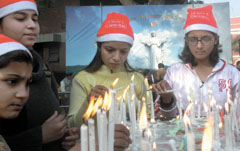 Devotees light up the candles before the Christmas prayers at the Gole Dakhana church in the Capital on Tuesday.