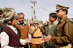 Rohtak SSP Hanif Qureshi and SDM Mukul Kumar placate protesting industrial unit workers at Rohtak on Tuesday.