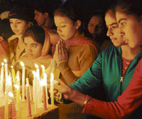 Girls light candles on the occasion Christmas at Asenson Church in Karnal on Tuesday evening.