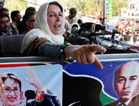Pakistans former Prime Minister Benazir Bhutto gestures as she addresses her supporters during an election public meeting at Lodhran in Punjab on Tuesday.