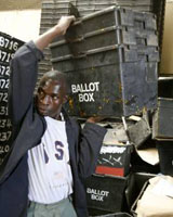 A worker with the Electoral Commission of Kenya carries ballot boxes, which will be used in the countrys upcoming elections, at a storage facility in Nairobi, on Tuesday.