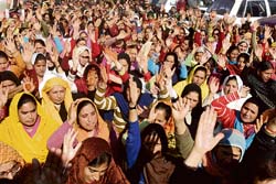 Anganwari workers and daily-wagers stage a dharna in front of old secretariat in Jammu on Thursday. 
