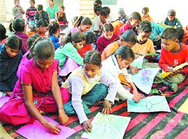 Students of a school run under the National Child Labour Project attend a drawing class at Basti Peer Dad in Jalandhar.