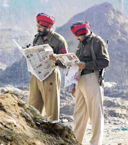 Two cops busy reading newspapers on a cold morning in Ludhiana on Thursday.