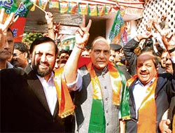 Jubilant BJP chief Rajnath Singh flashes the victory sign at the partys headquarters in Delhi.