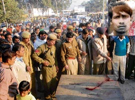 Police officials inspect the spot near the bus stand in Karnal where a taxi driver, Pawan Kumar (inset), was shot dead on Friday.