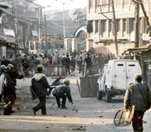 Protesters throw stones at security personnel during a protest in Srinagar on Friday in the wake of the assassination of former Pakistani Prime Minister Benazir Bhutto.