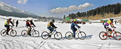 Participants of snow cycling competition in action during a snow festival held recently at Gulmarg.