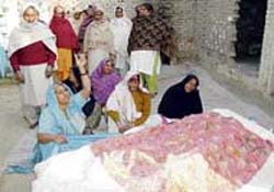 Relatives mourn the death of a woman and her daughter in an accidental fire in Mithewal village.