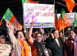 BJP workers welcome Gujarat Chief Minister Narendra Modi on his arrival at Indira Gandhi Airport in the Capital on Saturday. 