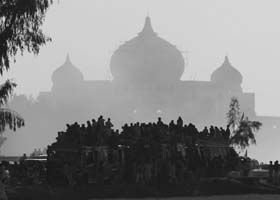 Benazirs supporters seen silhoutted at her family mausoleum in Gari Khuda Bakash near Larkan, Pakistan