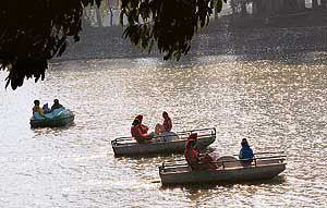 Visitors enjoy boating on a sunny day at the Karna lake in Karnal on Sunday.