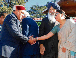 Rajasthan Chief Minister Vasundhara Raje greets Dhumal as Punjab Chief Minister looks on.