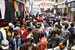 Locals buy woollens from roadside stalls in Raghnath Bazaar, Jammu.
