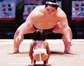 Mountain & Molehill: Fortunately, this girl didnt have to fight against the sumo wrestler  she just got some tips from him at an event in Hawaii. 