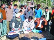 NGO representatives collect seeds from a Pathankot village on Monday.