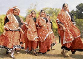 Girls return back to their school after performing at the inauguration of traffic safety week at Sector 23 in Chandigarh on Tuesday.