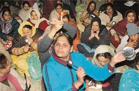Disgruntled teachers raise slogans and beat utensils outside the residence of Harcharanjit Kaur Brar, DPI (elementary), in Sector 37, Chandigarh, on Tuesday.