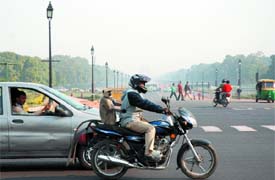 Langoors are proving effective to curb monkey menace. Here is one on the pillion of a motorcyclist, at Rajpath in the Capital on Tuesday.