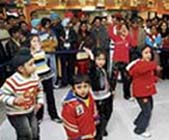 Kids dance in a mall.