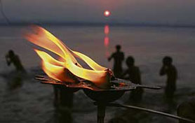 A devotee offers prayers during the early morning at Sangam in Allahabad on Tuesday.