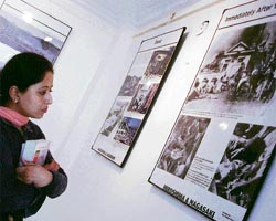 A student of Jammu University looks at photos of atom bomb attacks on the twin cities of Japan during 