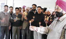 Employees of the Customs and Central Excise Department took out a candlelight protest in front of the commissioners office in Rishi Nagar, Ludhiana, on Wednesday.