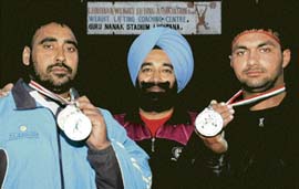 Medal winning weightlifters with their coach Harbans Singh at Guru Nanak Stadium in Ludhiana. 