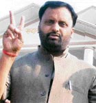 SP candidate Niraj Sekhar shows the victory sign after winning the Baliya byelection in Varanasi on Wedensday.
