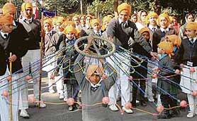 A child plays gatka at nagar kirtan in connection with Gurpurb in Chandigarh on Thursday.