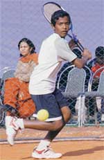 A player returns a shot during St. Peter open Tennis Tournament in Chandigarh on Thursday.