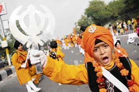 A Sikh boy dressed as a Panj Pyara leading his contingent in the Parkash Utsav procession in Jammu